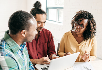 A woman is discussing a project with two men. A woman is discussing a project with two men.
